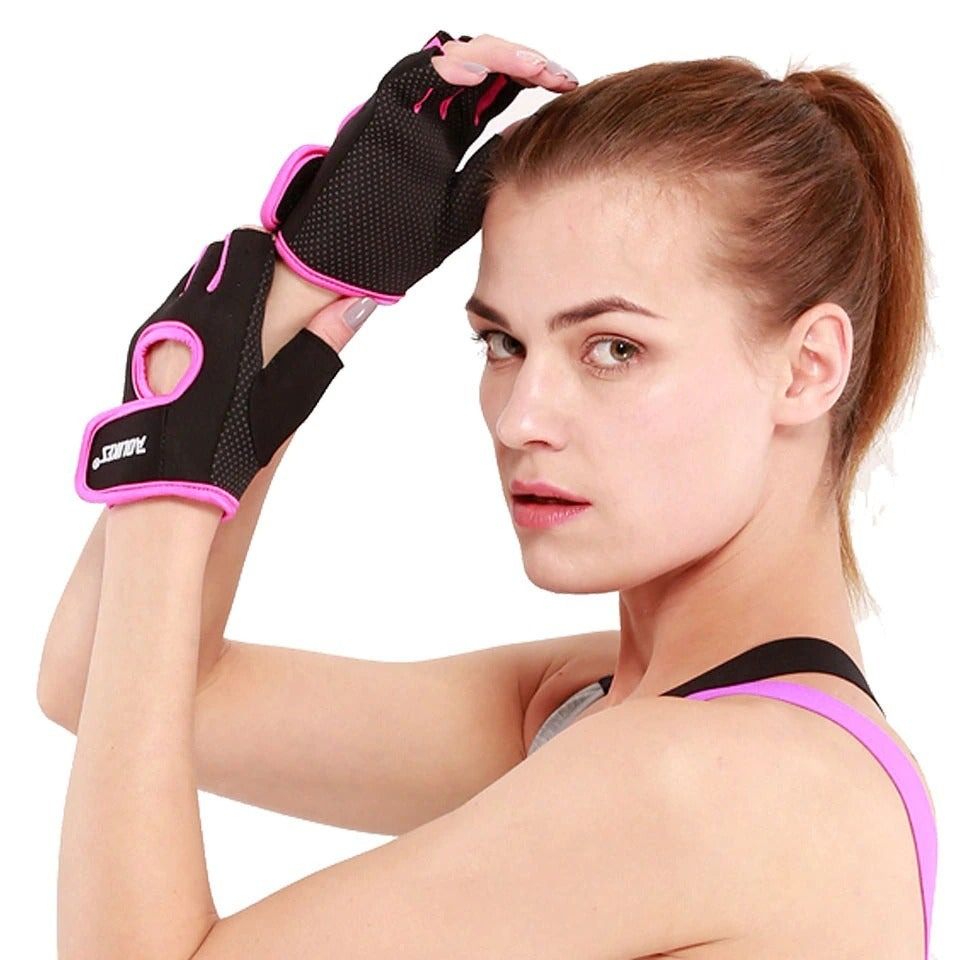 Woman wearing black and pink anti-slip half finger gym gloves for workout grip and hand protection